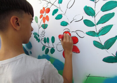 Momentaufnahmen von der Graffiti-Aktion der Dörlinbacher Jugend bei der Alten Schule. 15 Jugendliche eine triste Stützmauer in ein leuchtendes Wandbild.